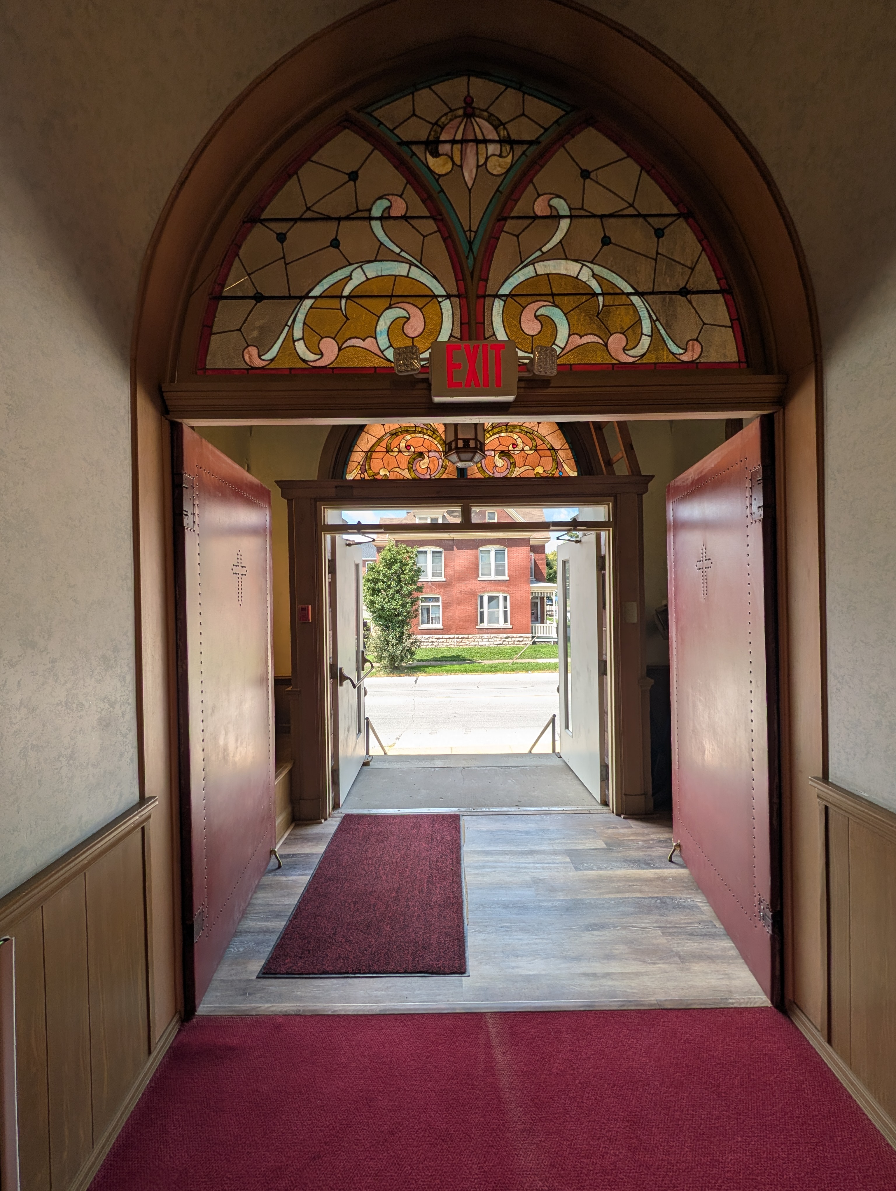 Open sanctuary doors viewed from inside the church